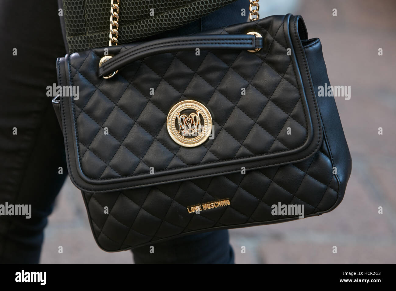 Woman with Love Moschino black leather bag before Salvatore Ferragamo  fashion show, Milan Fashion Week street style on September Stock Photo -  Alamy