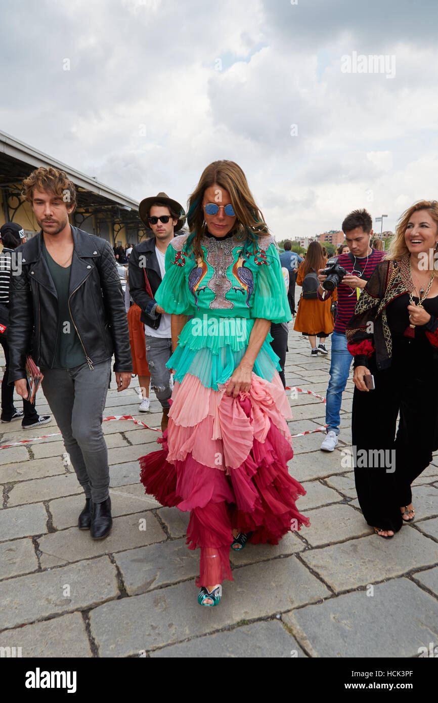 Anna dello Russo with long dress in pink red and turquoise colors before Gucci fashion show, Milan Fashion Week street style. Stock Photo