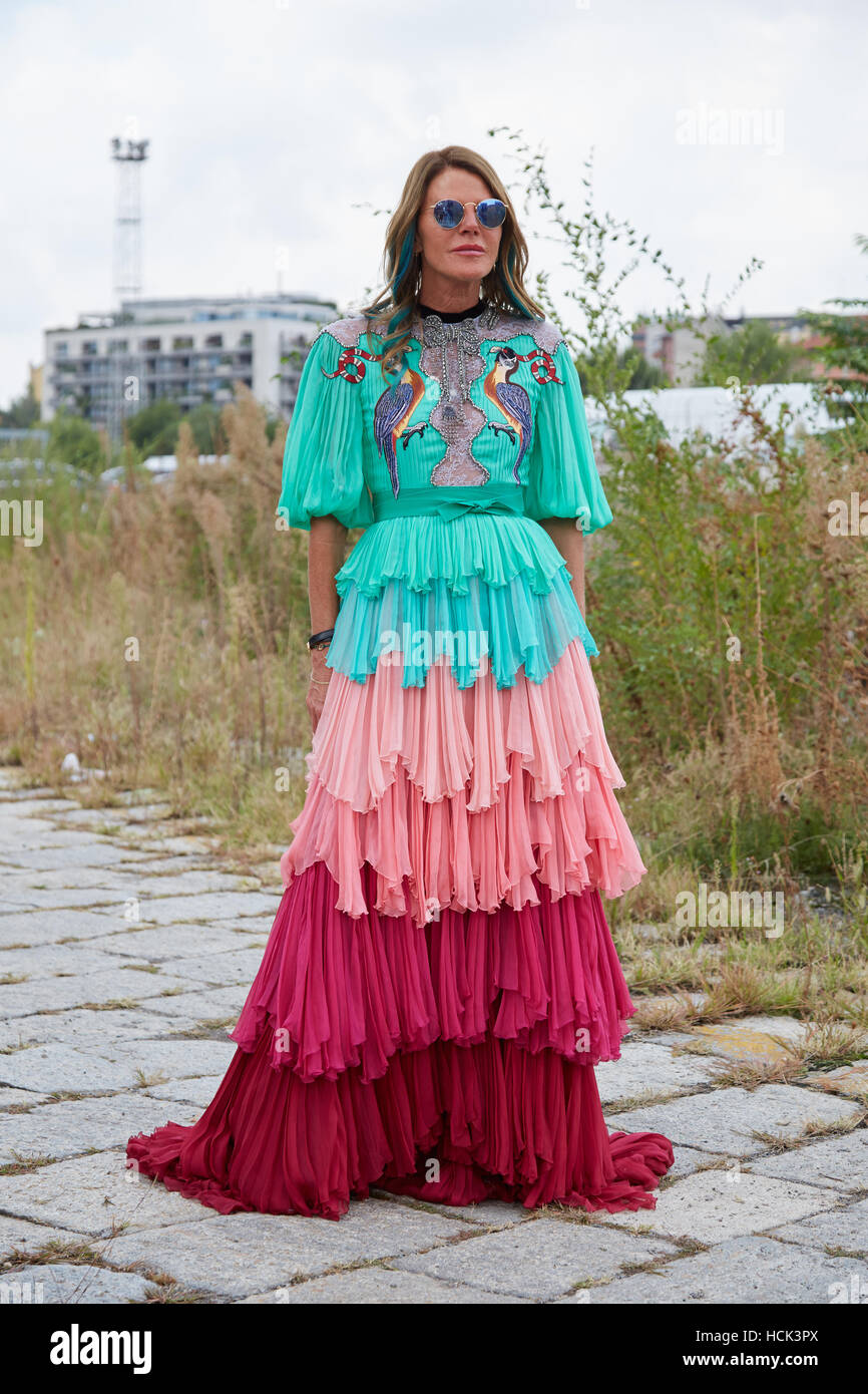 Anna dello Russo with long dress in pink red and turquoise colors before Gucci fashion show, Milan Fashion Week street style. Stock Photo