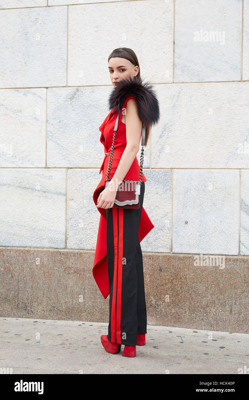 Woman with red and black clothes before Genny fashion show, Milan Fashion Week street style on September 22, 2016 in Milan. Stock Photo