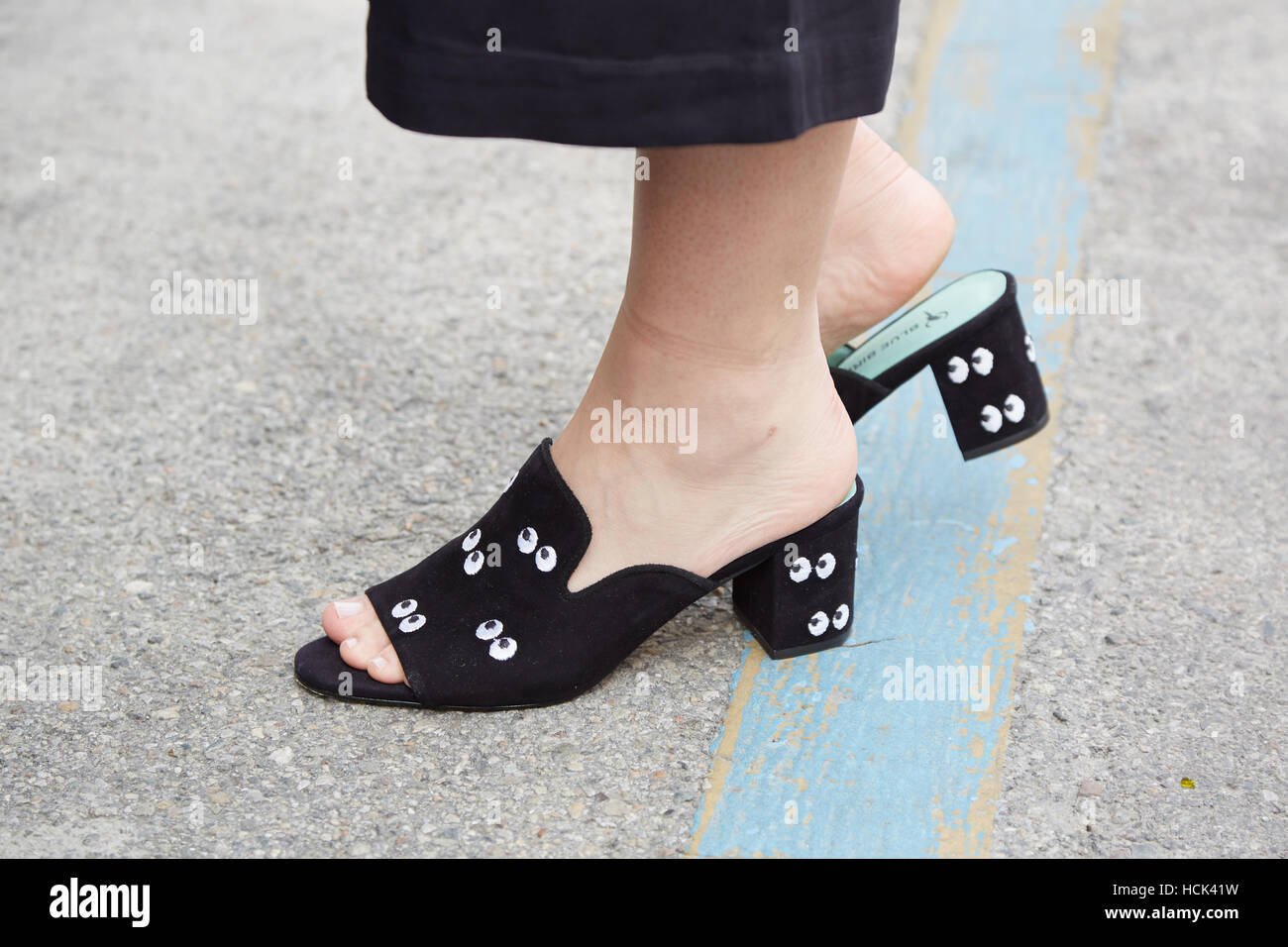Woman with sabot shoes with eyes pattern before Anteprima fashion show,  Milan Fashion Week street style on September 22 Stock Photo - Alamy