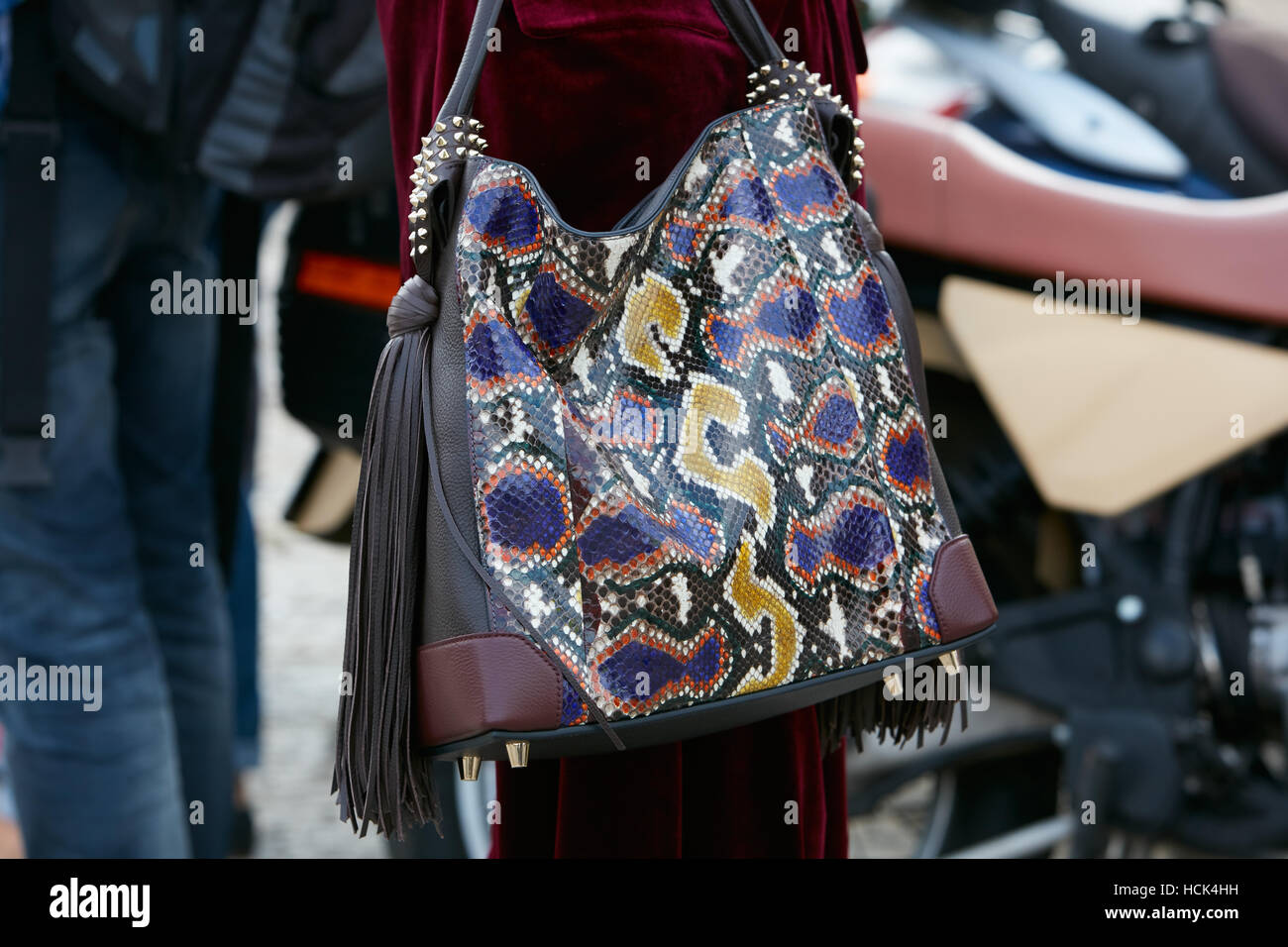 Woman with colorful snake leather and fringes before Gucci fashion show, Milan Fashion Week street style on September 21, 2016. Stock Photo