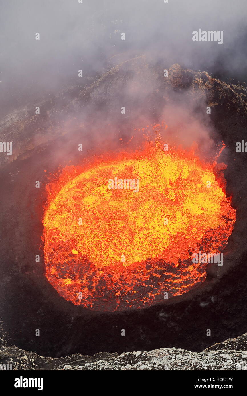 Bubbling burning lava lake inside the Mount Marum active crater in the