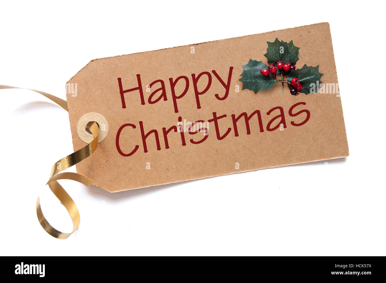 Happy Christmas handwritten on a label with holly leaves Stock Photo