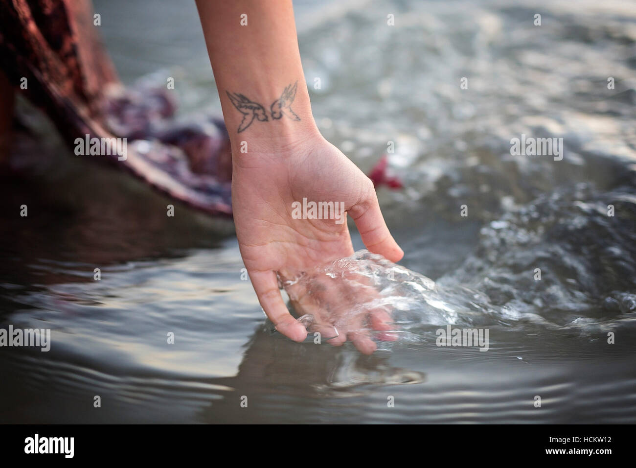 Woman's Hand in running water Stock Photo