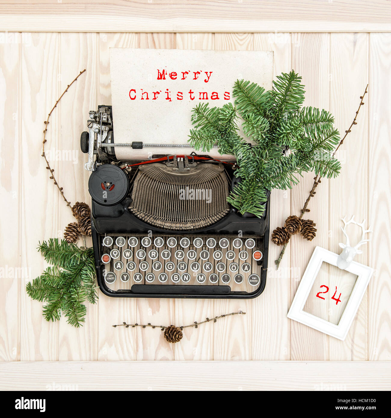 Vintage typewriter with christmas decoration evergreen tree brunches