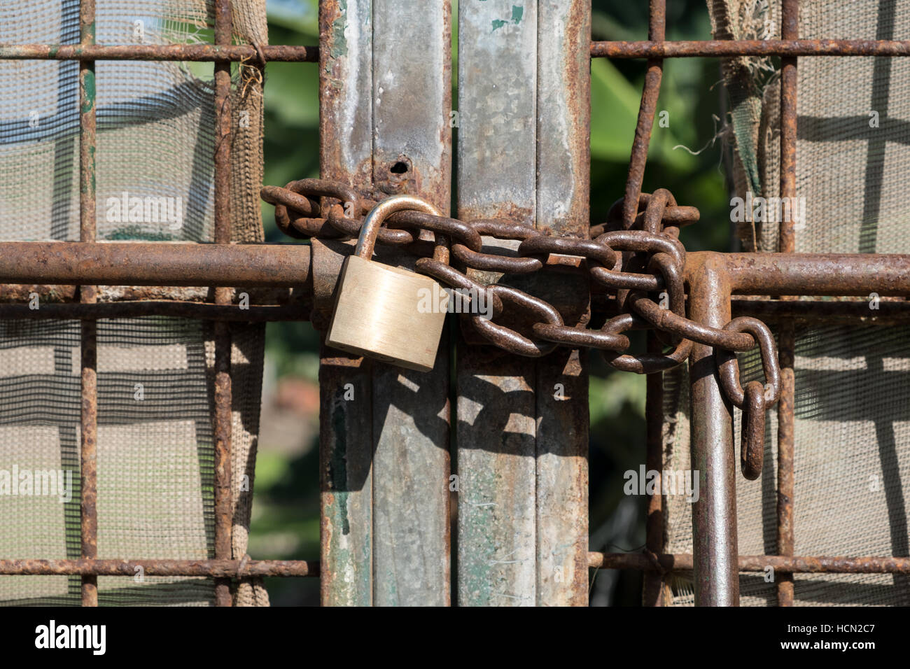 metal gate locked with chain and padlock Stock Photo