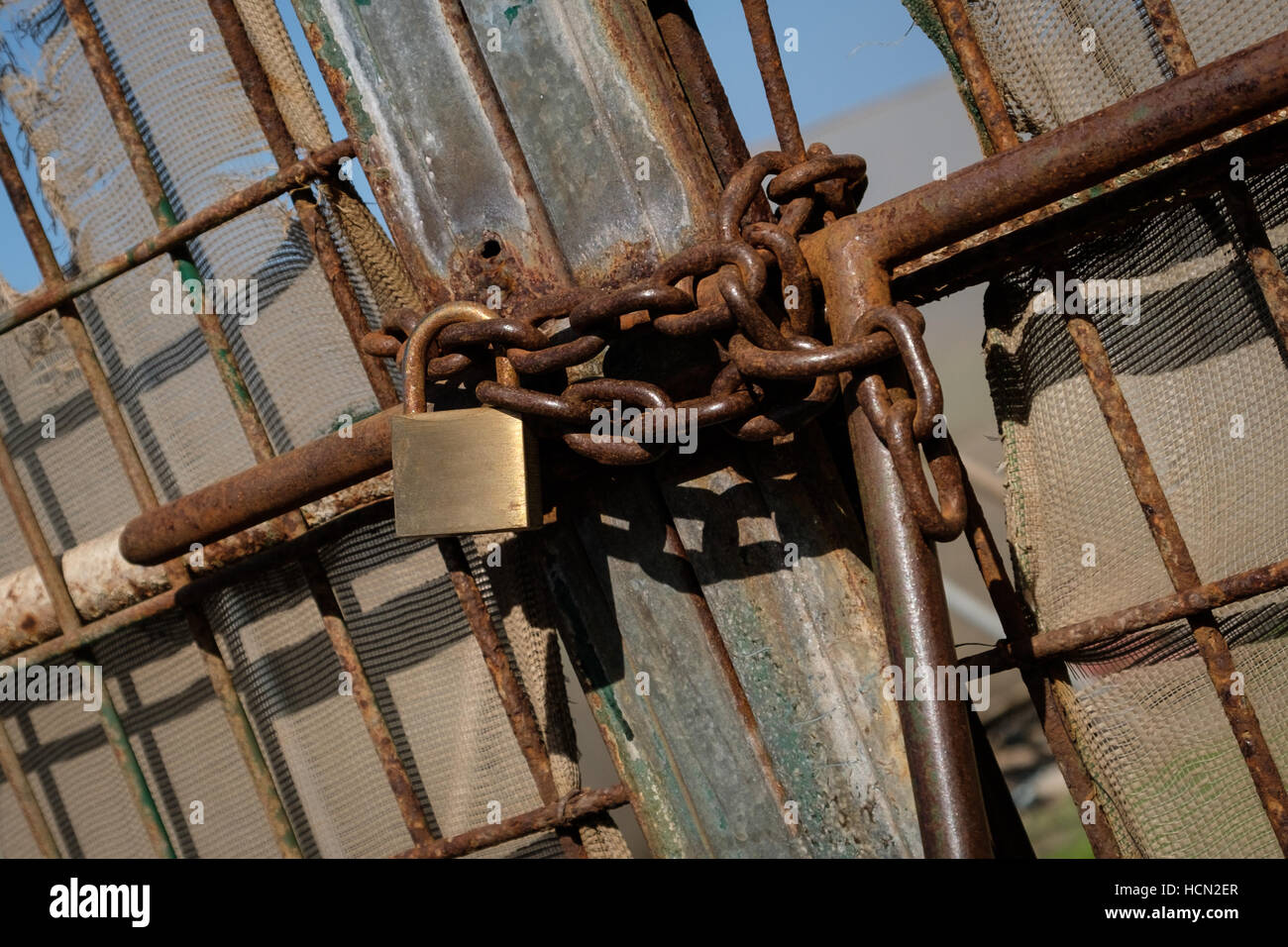 metal gate locked with chain and padlock Stock Photo