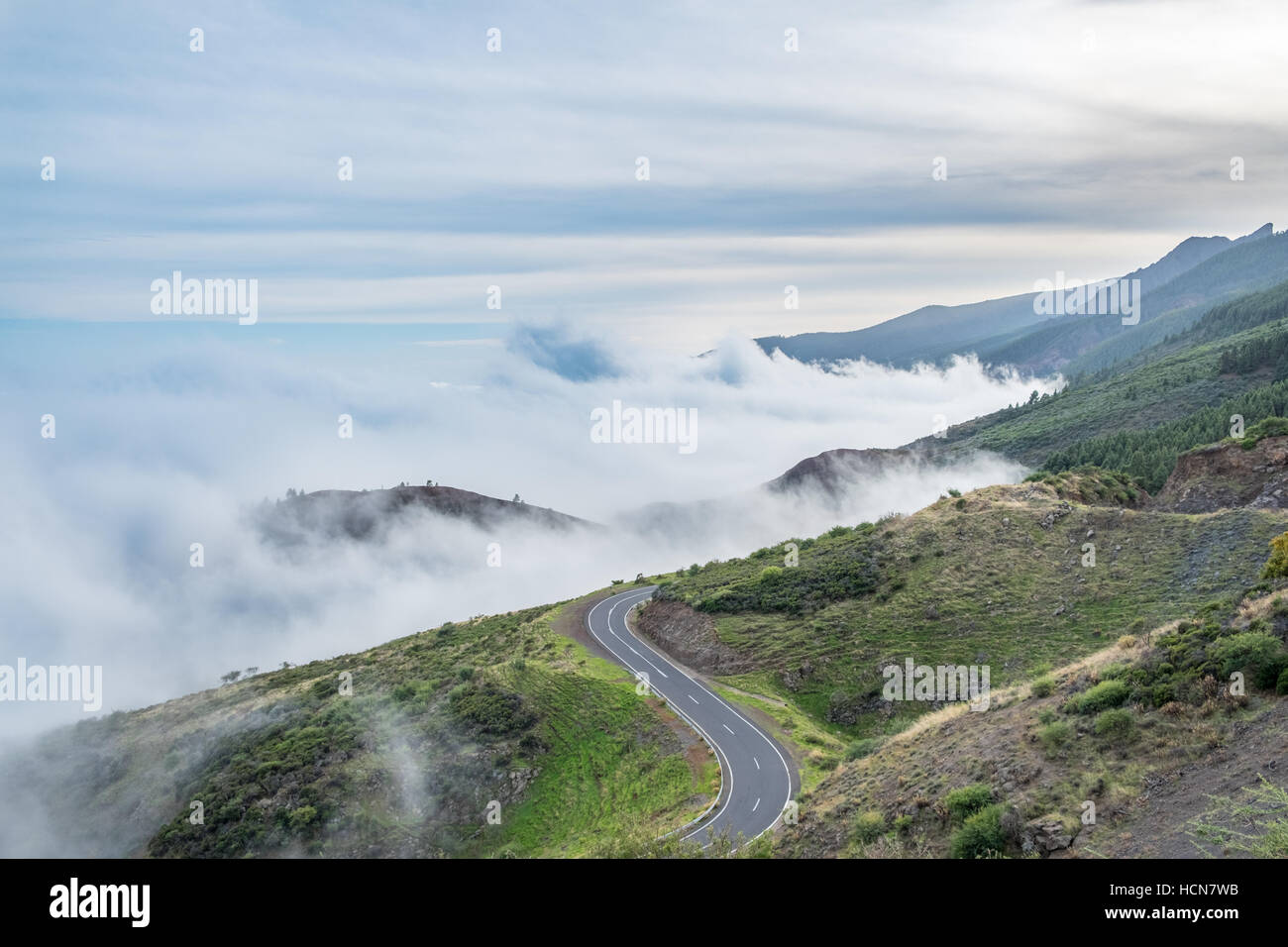 road in mountain landscape over clouds - cloudy panorama Stock Photo ...