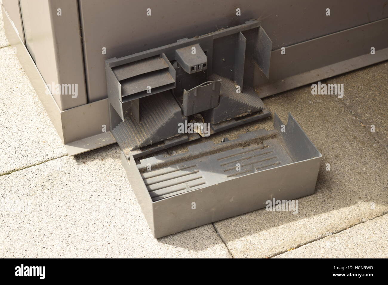 Small broken metal built rat trap on a city district corner Stock Photo ...