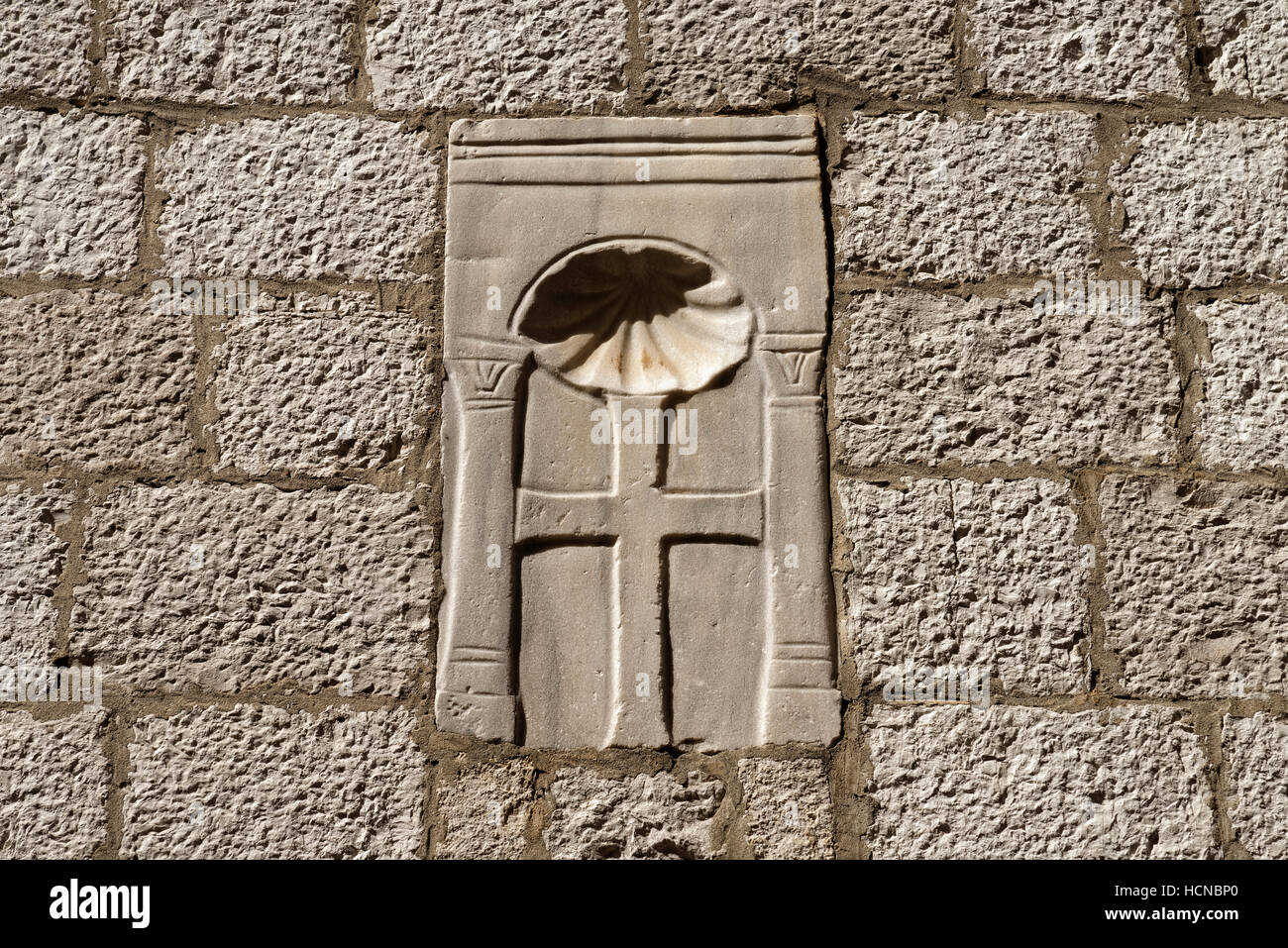 Porec, Porec: Cross with pilgrim mussel at the frontage of the Euphrasian Basilica, Istria, Croatia Stock Photo