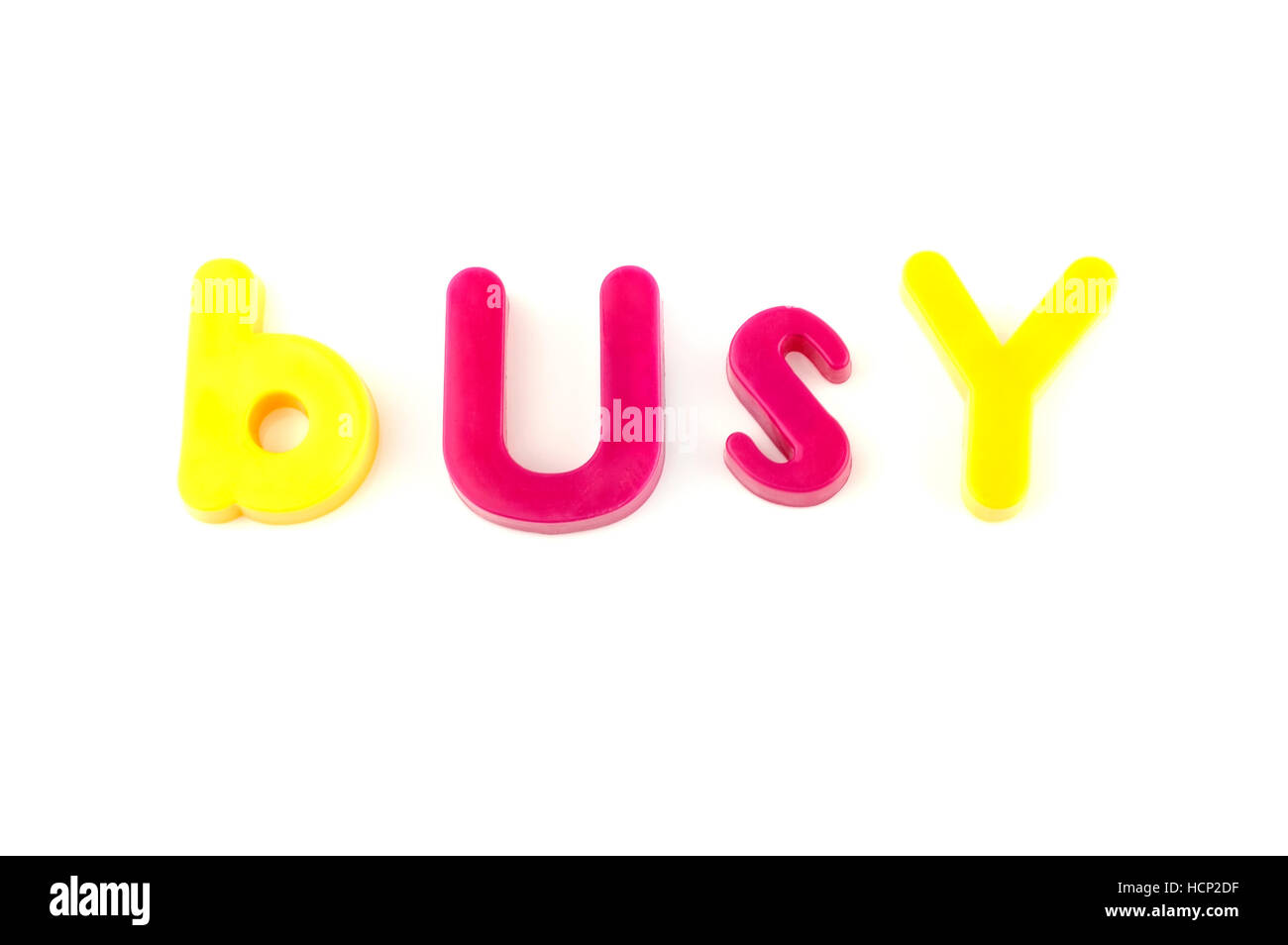 Word busy isolated on white background made from colorful toys letters