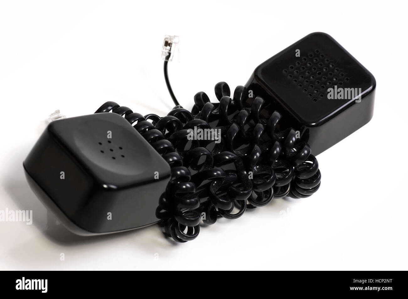Black phone tube got tied by telephone cord Stock Photo
