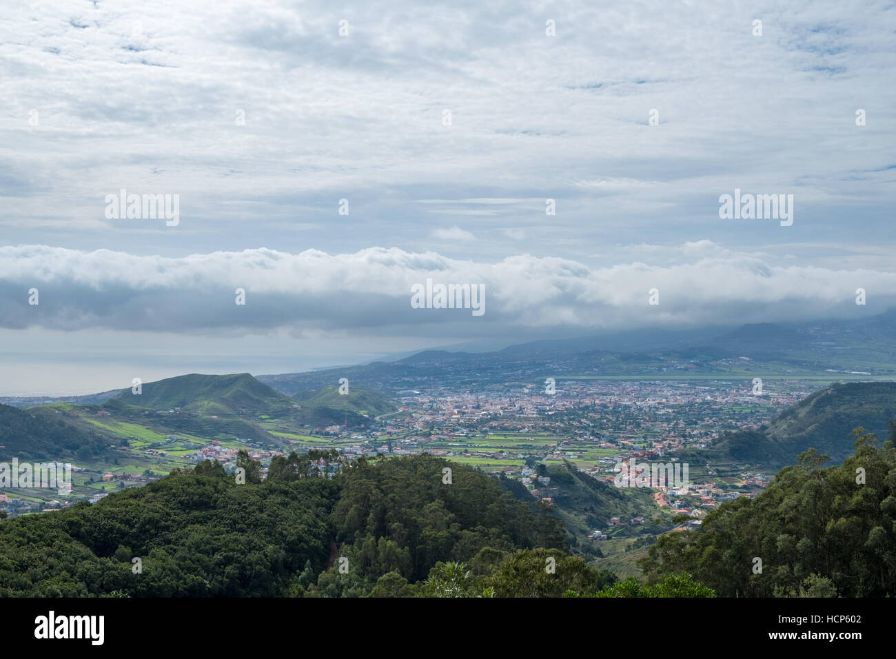 Green valley with village, hills and ocean background, Tenerife Stock Photo