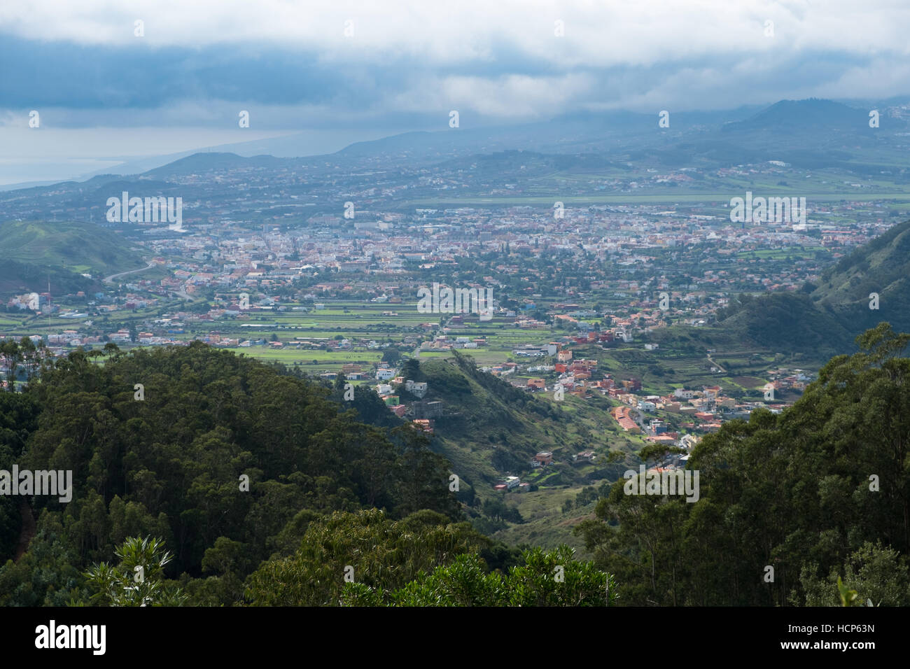 Green valley with village, hills and ocean background, Tenerife Stock Photo