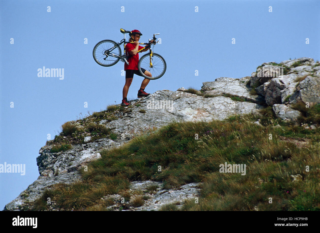 Cyclist carrying his mountainbike on the way to the summit of Schiefersteines, Reichraming, Upper Austria, Austria, Europe Stock Photo