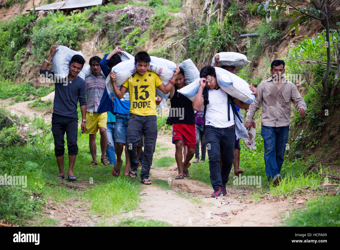 Locals carrying hybrid rice seed, Sindupalchuk, Nepal Stock Photo