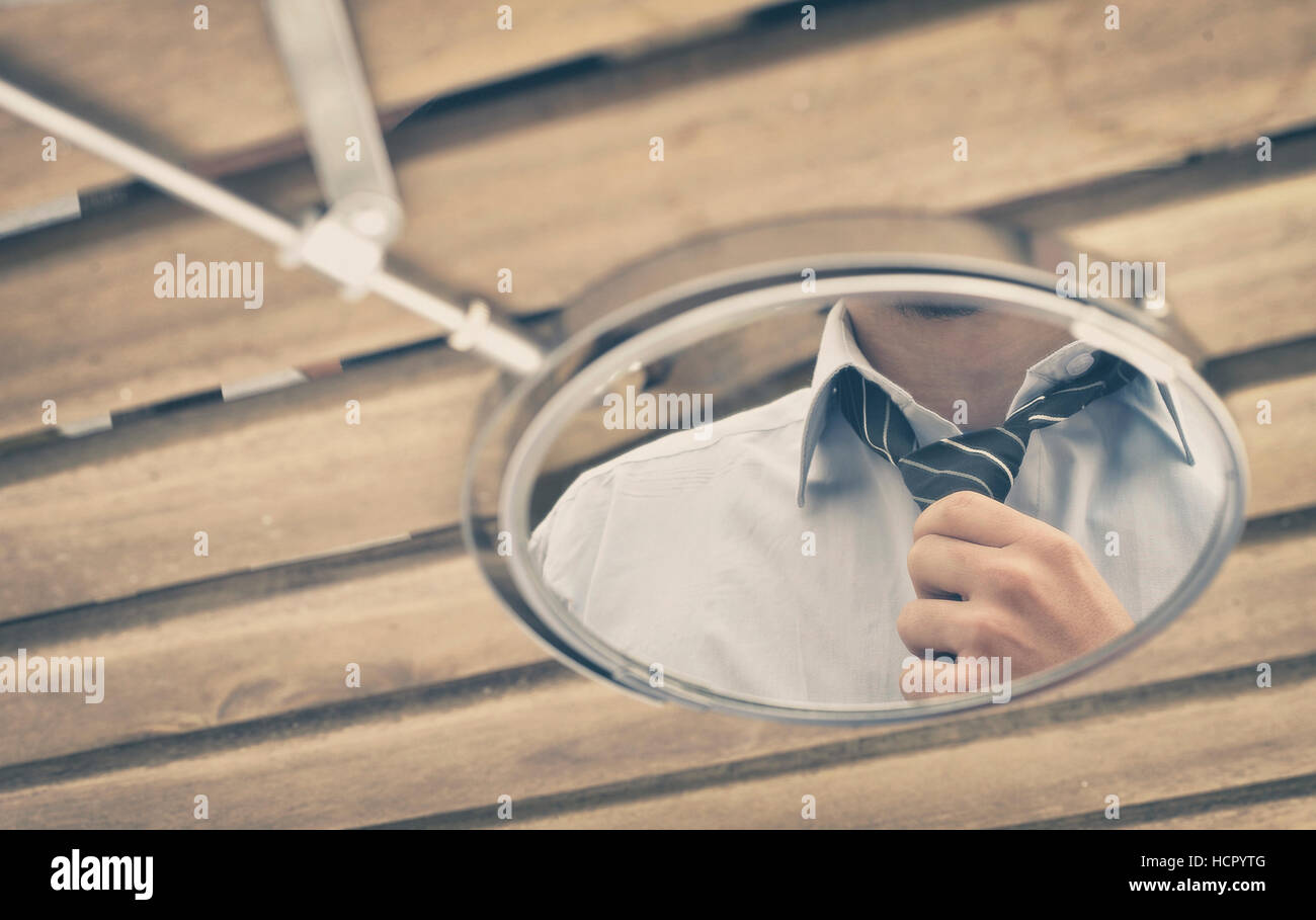 Man adjusting tie in mirror Stock Photo Alamy