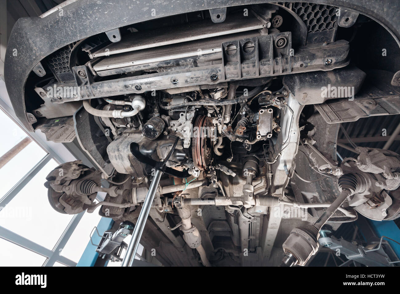Change and repair clutch, drive axle. working underneath a lifted car