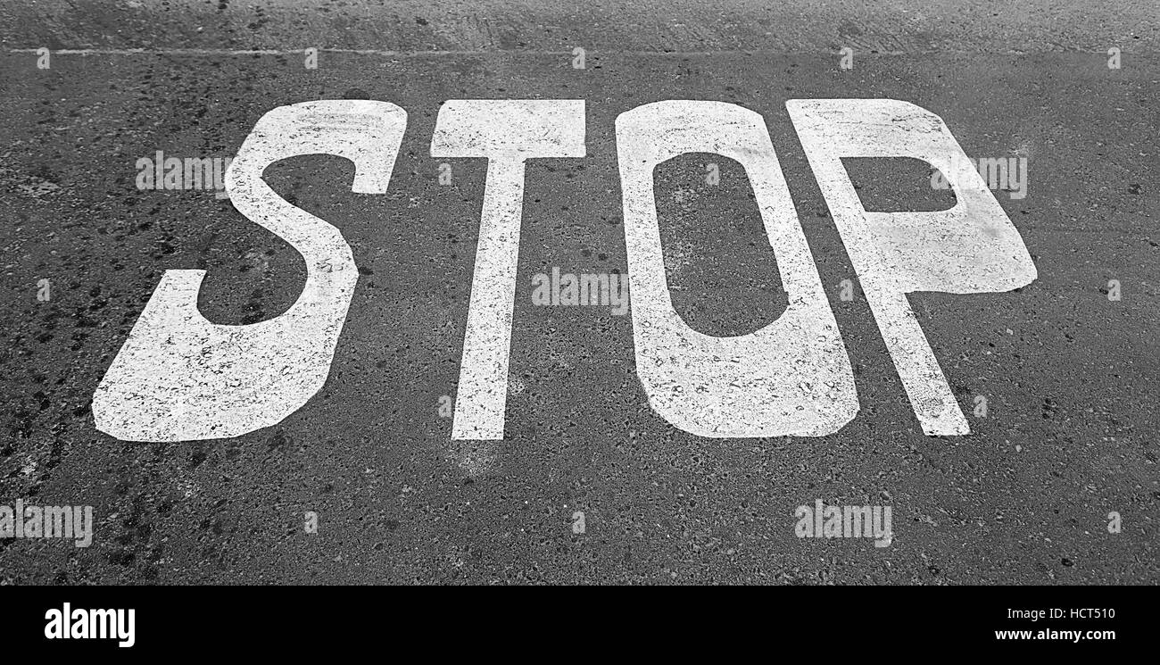 Stop sign on asphalt, detail of a traffic signal, security and prohibition Stock Photo