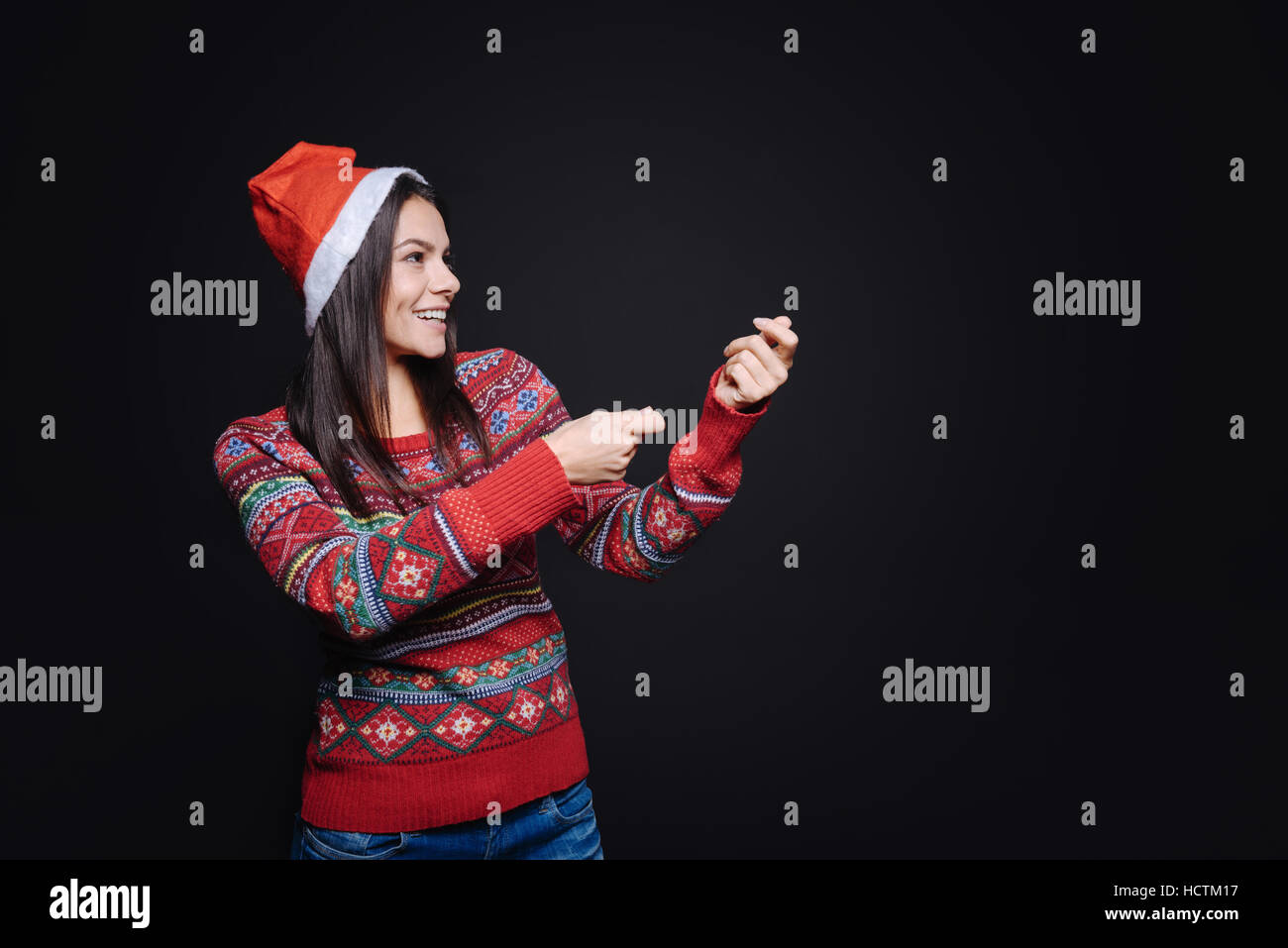 Amused girl holding an invisible petard Stock Photo