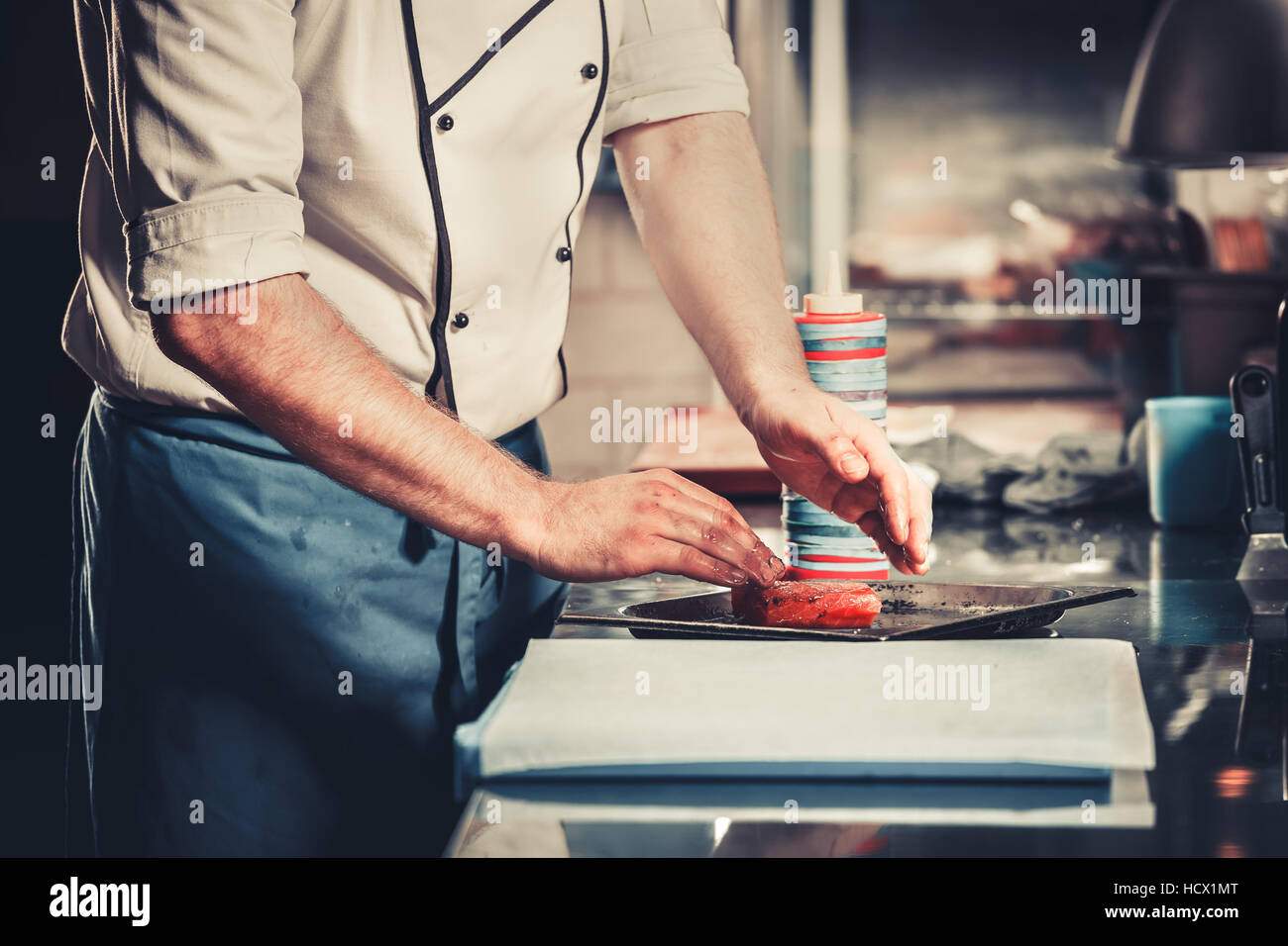 Chef prepares dish in the kitchen Stock Photo
