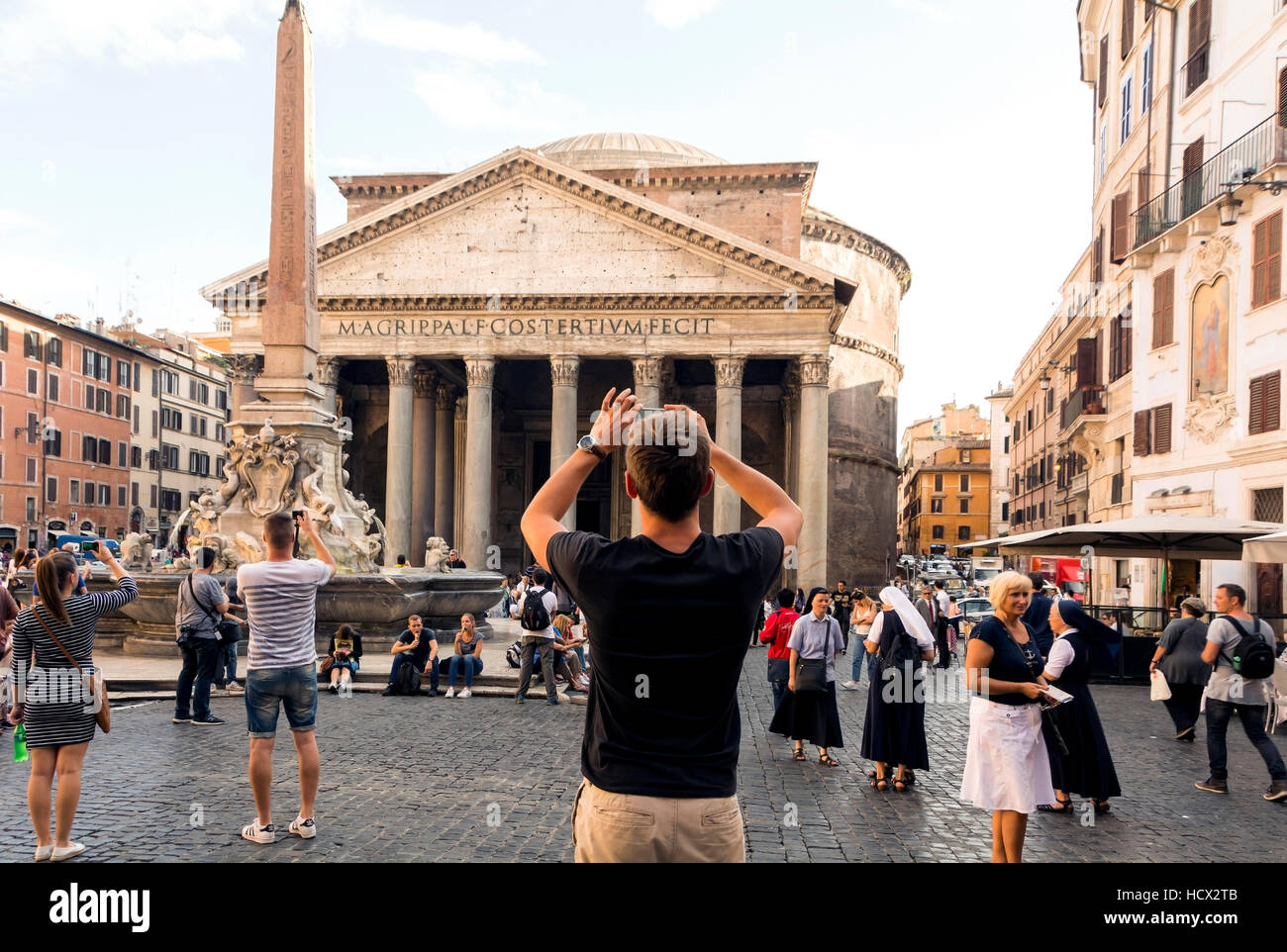 Tourists taking photos and admiring the Pantheon in Rome, Italy. Stock Photo