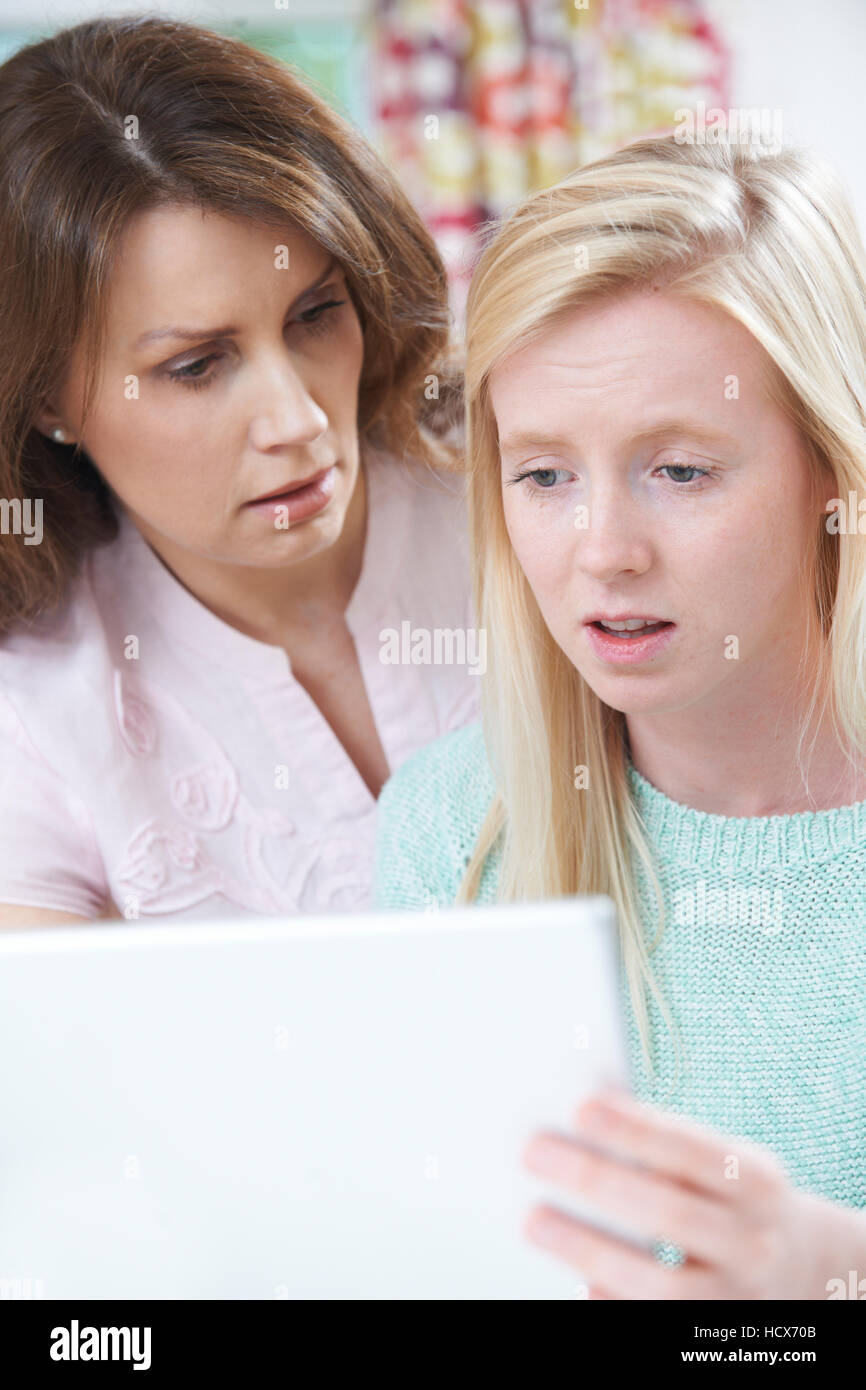 Mother Comforting Daughter Victimized By Online Bullying Stock Photo