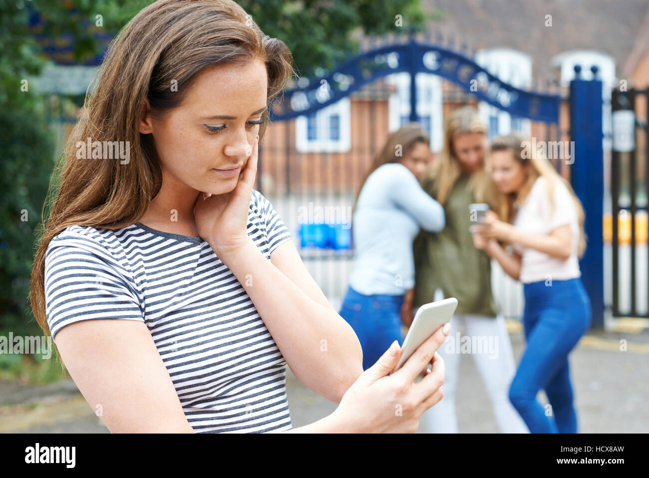 Teenage Girl Being Bullied By Text Message Stock Photo
