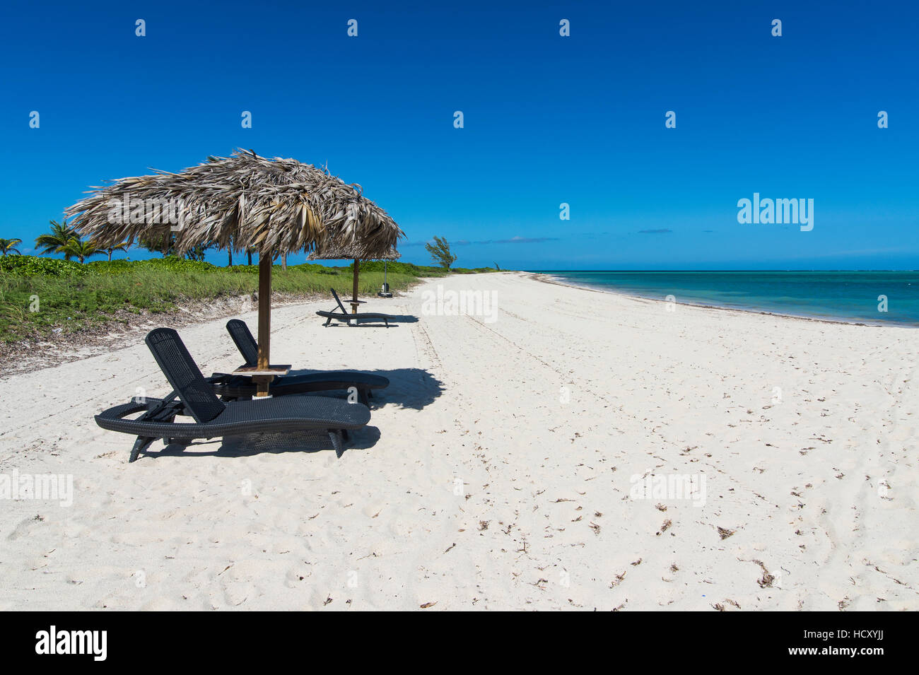 Sun lounger on a white sand beach in northern Providenciales, Turks and Caicos, Caribbean Stock Photo