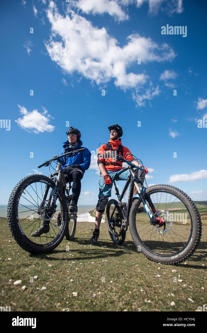 Mountain biking along the chalk cliffs coastal path on the South Downs Way, South Downs National Park, East Sussex, UK Stock Photo