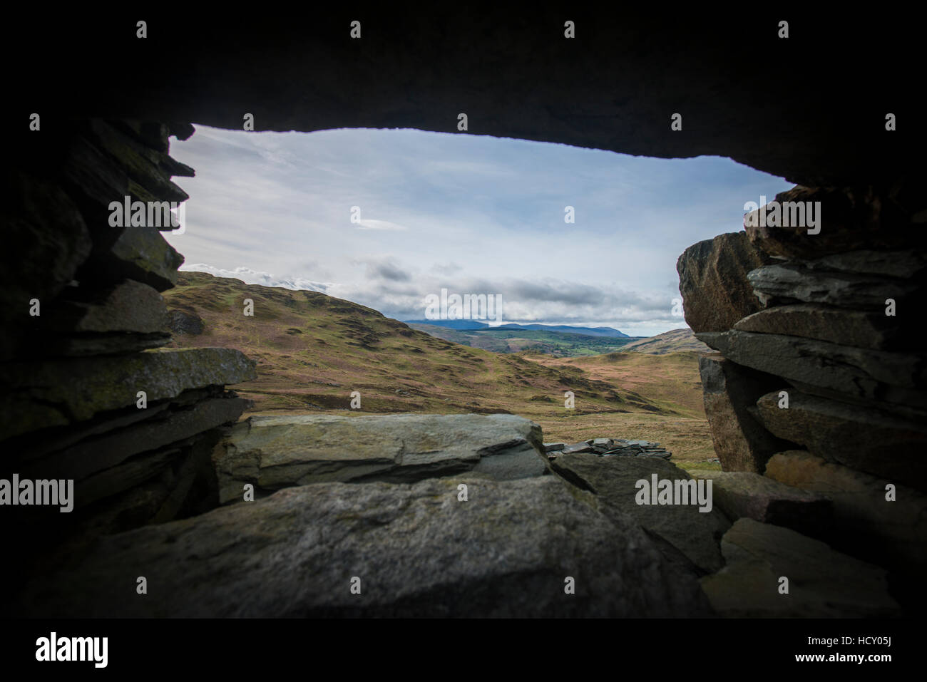Looking through a window of a crumbling stone house on Place Fell in the English Lake District, Cumbria, UK Stock Photo