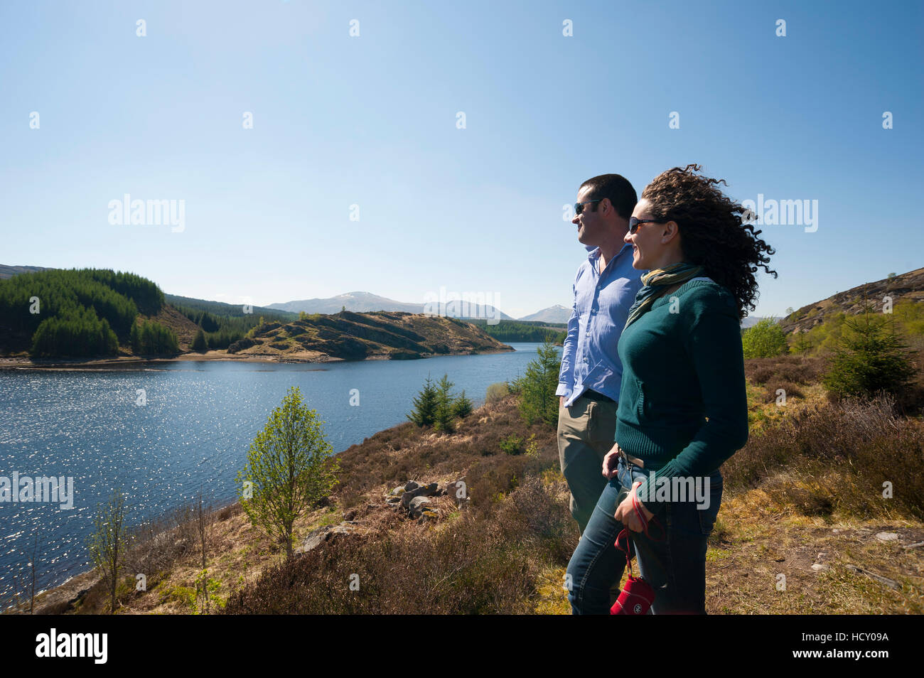 Tourists look out across Loch Laggan, Aberdeenshire, Scotland, Uninted Kingdom Stock Photo