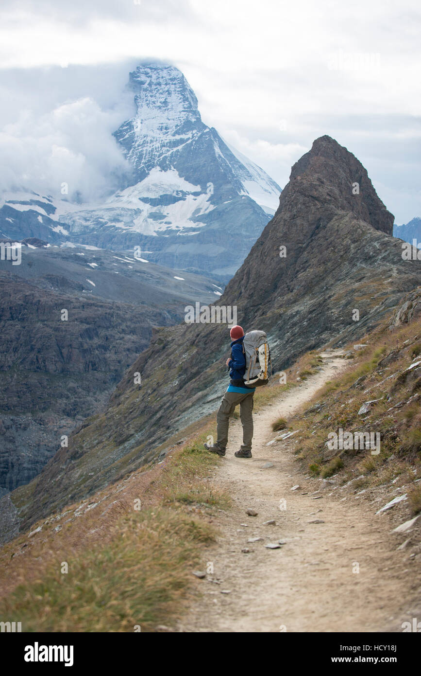 Hiking a trail in the Swiss Alps near Zermatt with a view of The Matterhorn in the distance, Zermatt, Valais, Switzerland Stock Photo