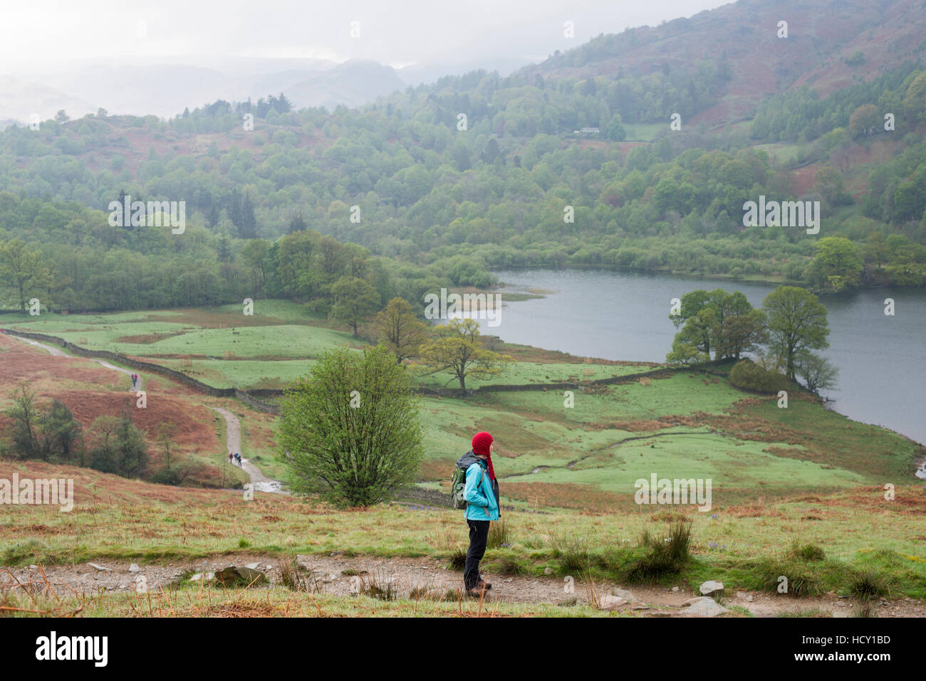 A woman looks out over Rydal Water near Grasmere, Lake District National Park, Cumbria, UK Stock Photo
