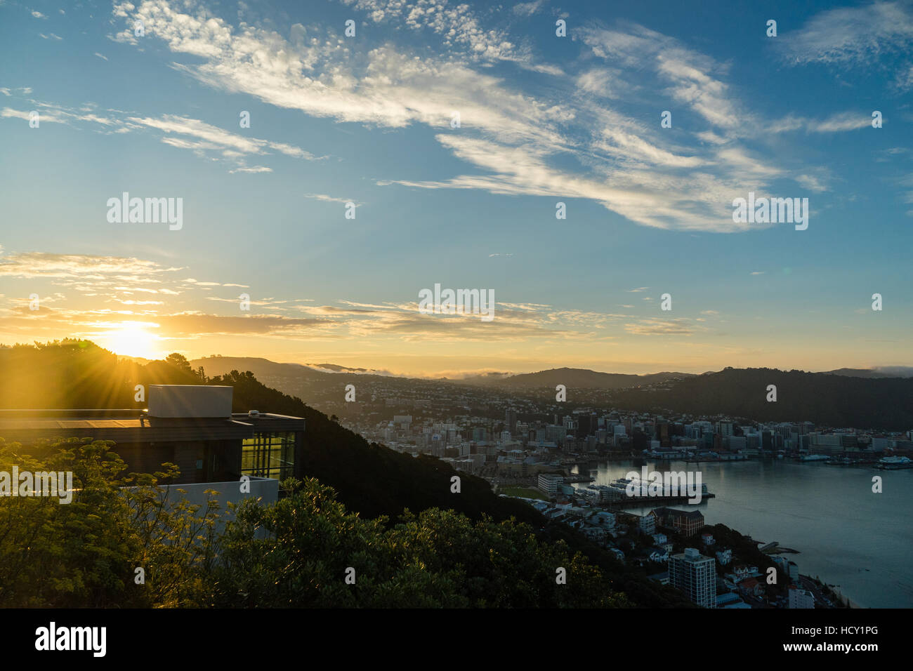 The sun sets over a new home atop Mount Victoria in Wellington, North Island, New Zealand Stock Photo