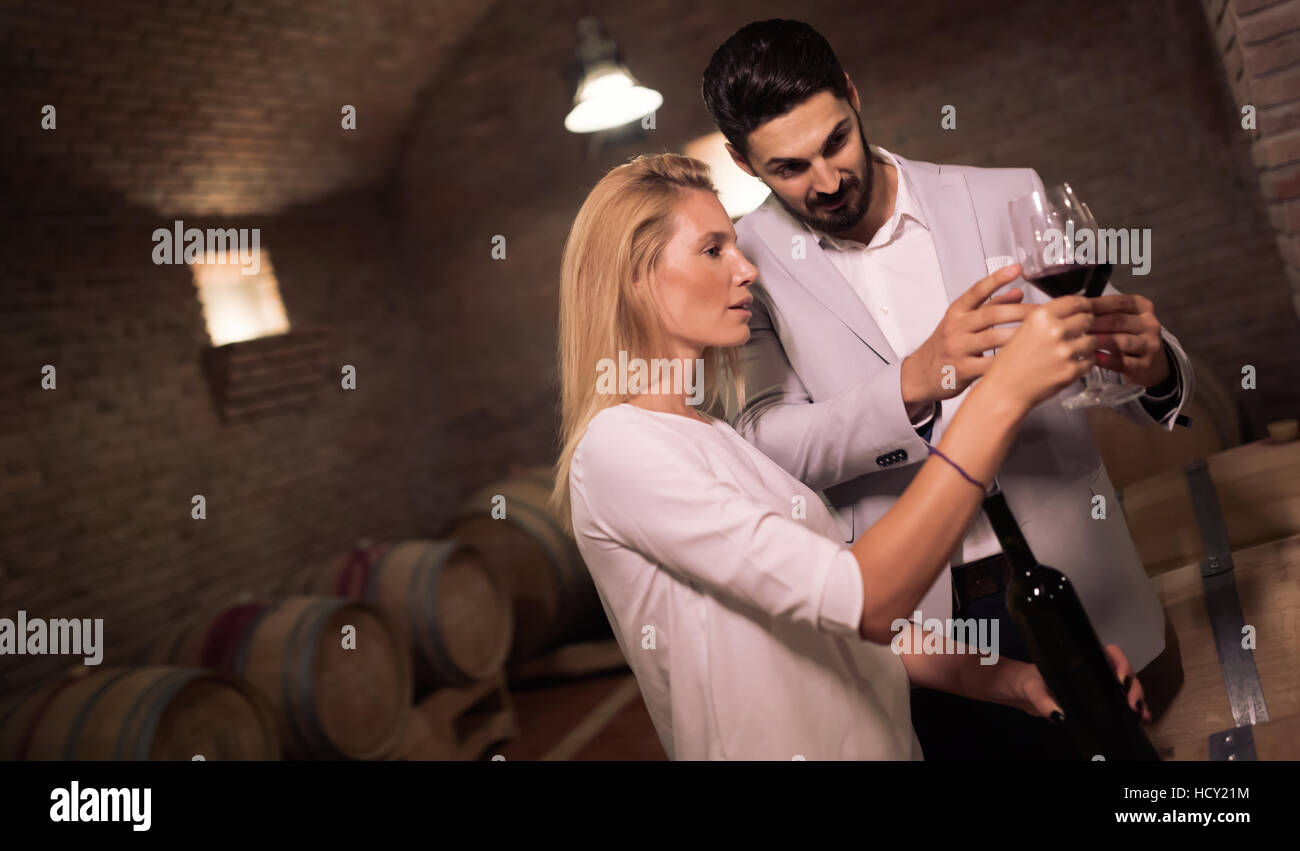 People tasting red wine in winery basement Stock Photo - Alamy