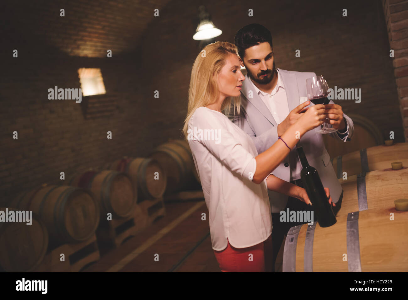 People tasting wine in winery basement Stock Photo - Alamy