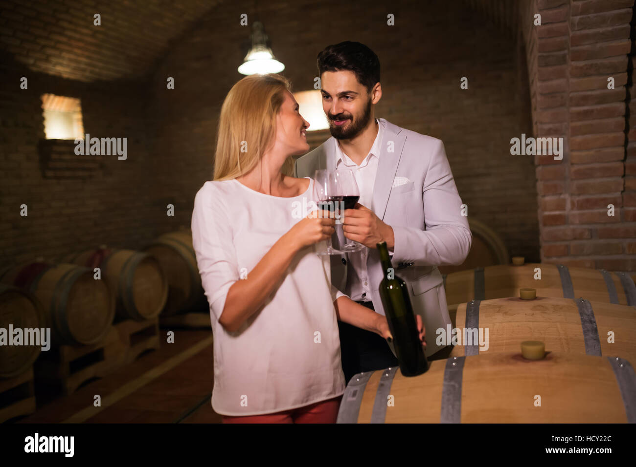 People tasting red wine in winery basement Stock Photo - Alamy
