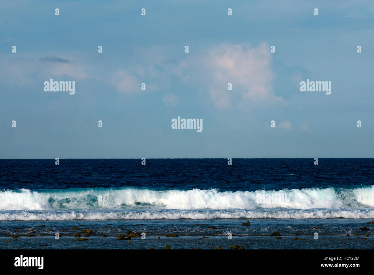 Tropical sea with waves and blue sky background Stock Photo - Alamy