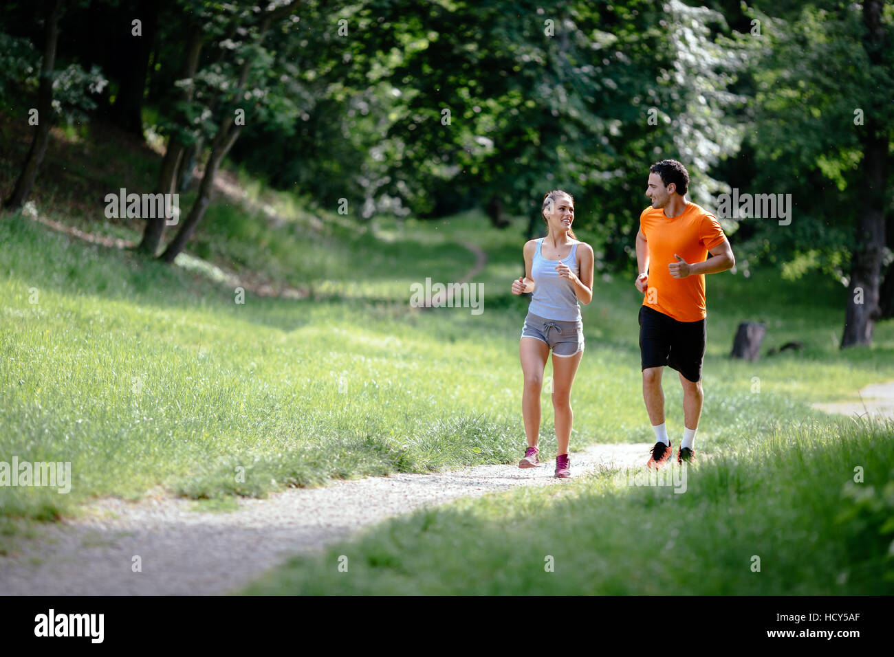 Couple jogging and running outdoors in nature Stock Photo - Alamy
