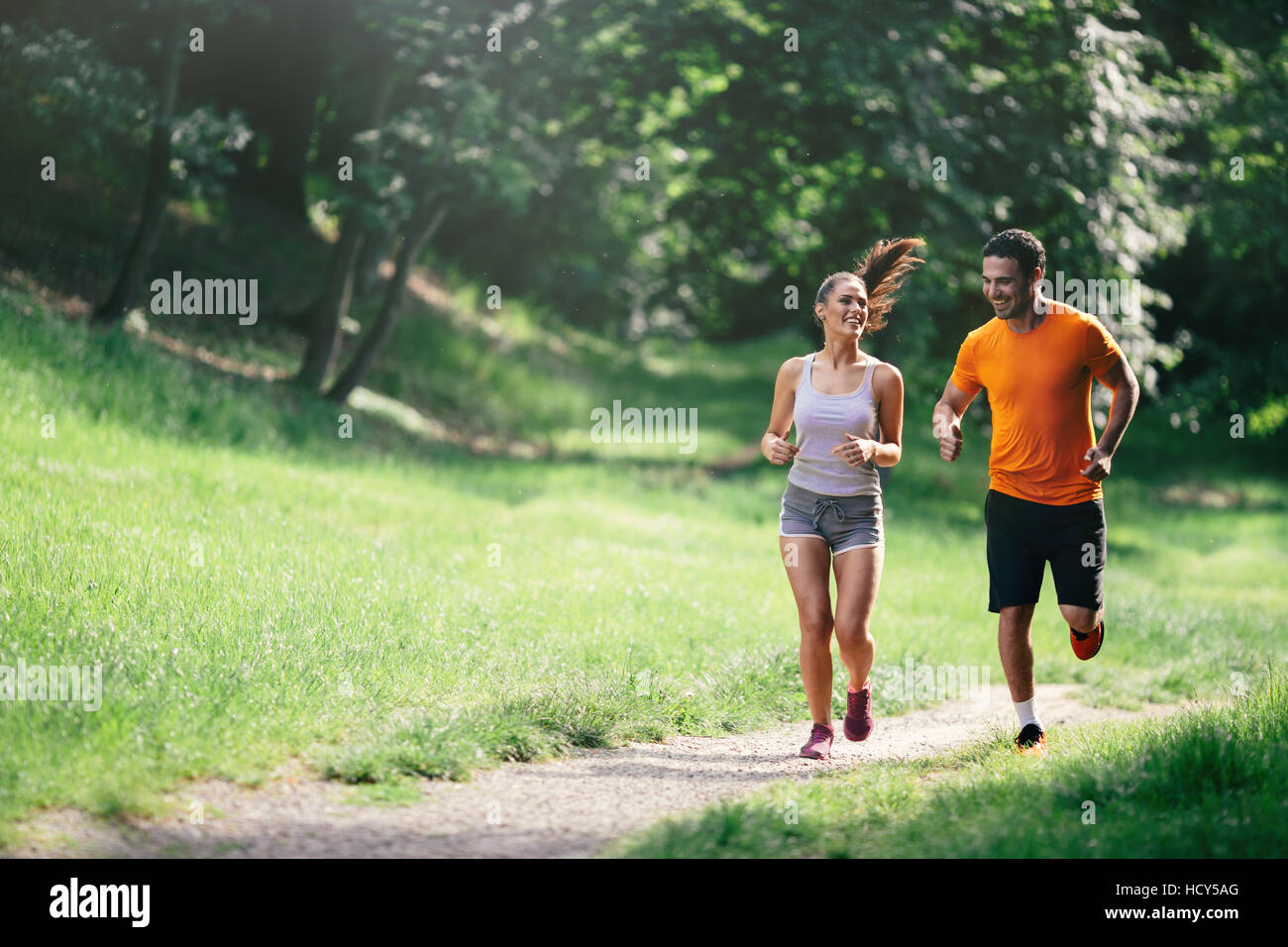 Couple jogging and running outdoors in nature Stock Photo - Alamy