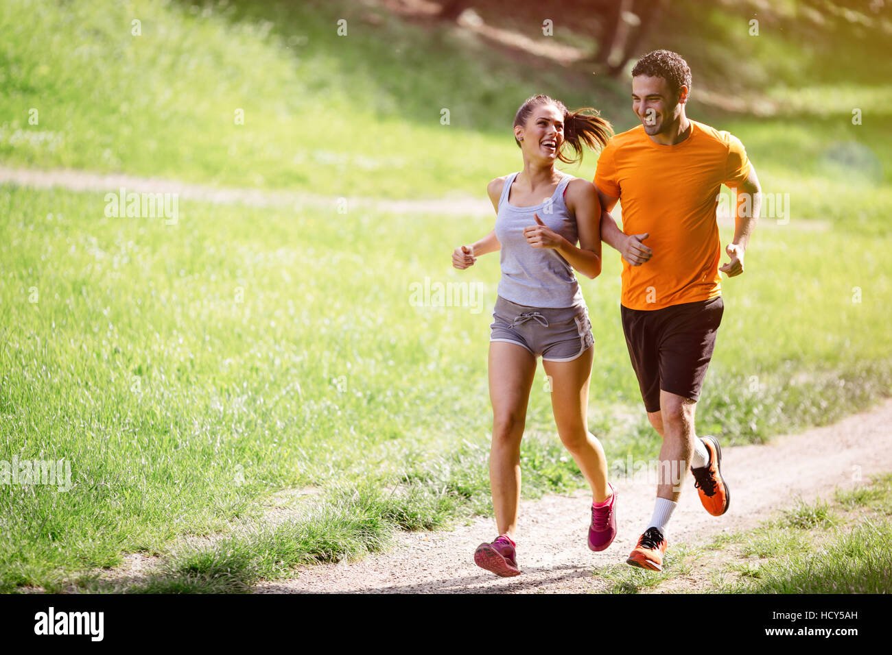 Couple jogging and running outdoors in nature Stock Photo - Alamy