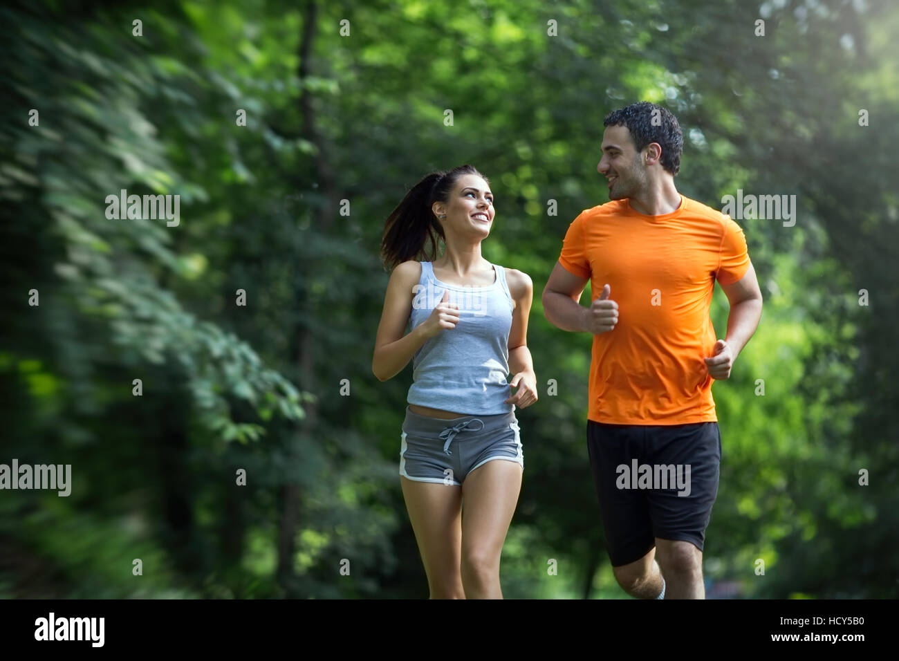 Couple jogging and running outdoors in nature Stock Photo - Alamy