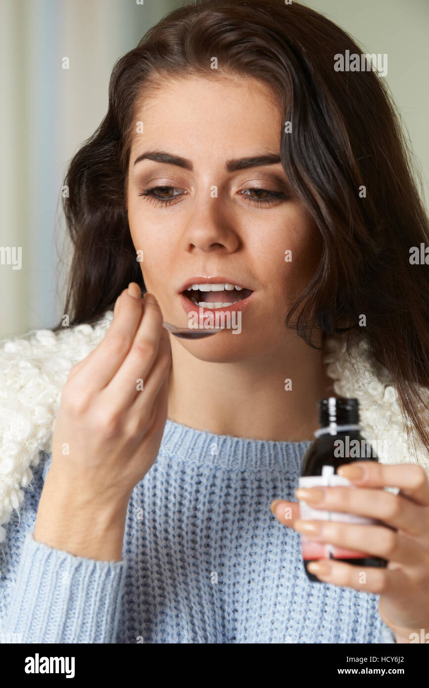 Woman With Cold Taking Medicine On Spoon Stock Photo