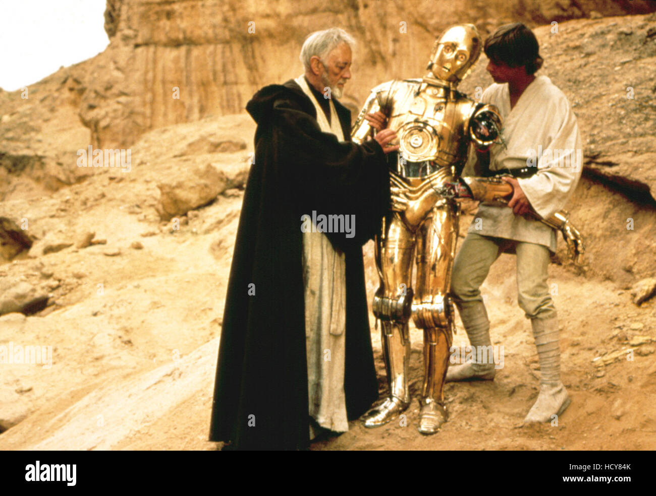 STAR WARS, (aka STAR WARS: EPISODE IV - A NEW HOPE), Alec Guinness, Anthony Daniels as C-3PO, Mark Hamill, 1977 Stock Photo