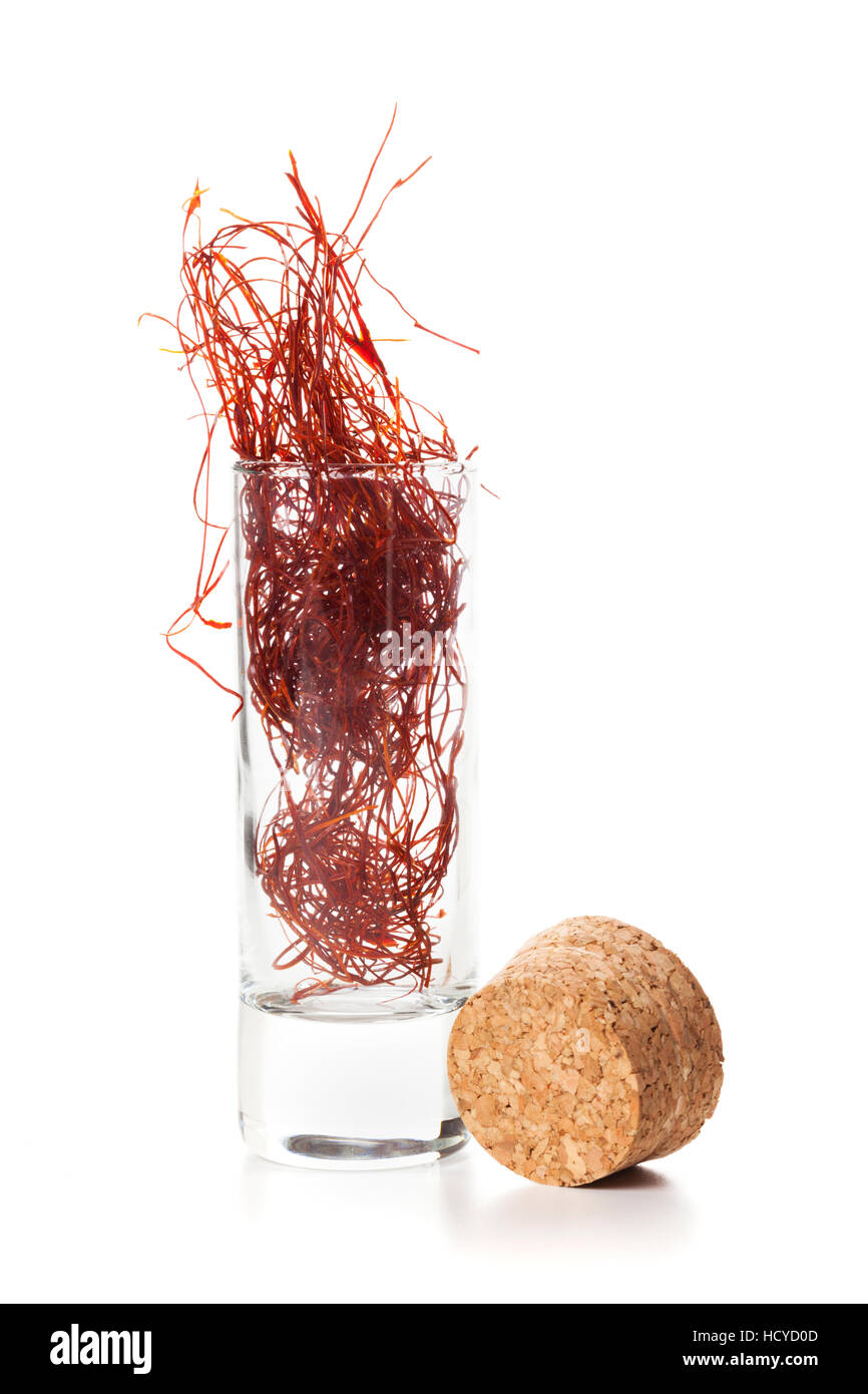 chili threads in an opened glass with cork aside, isolated on white ...