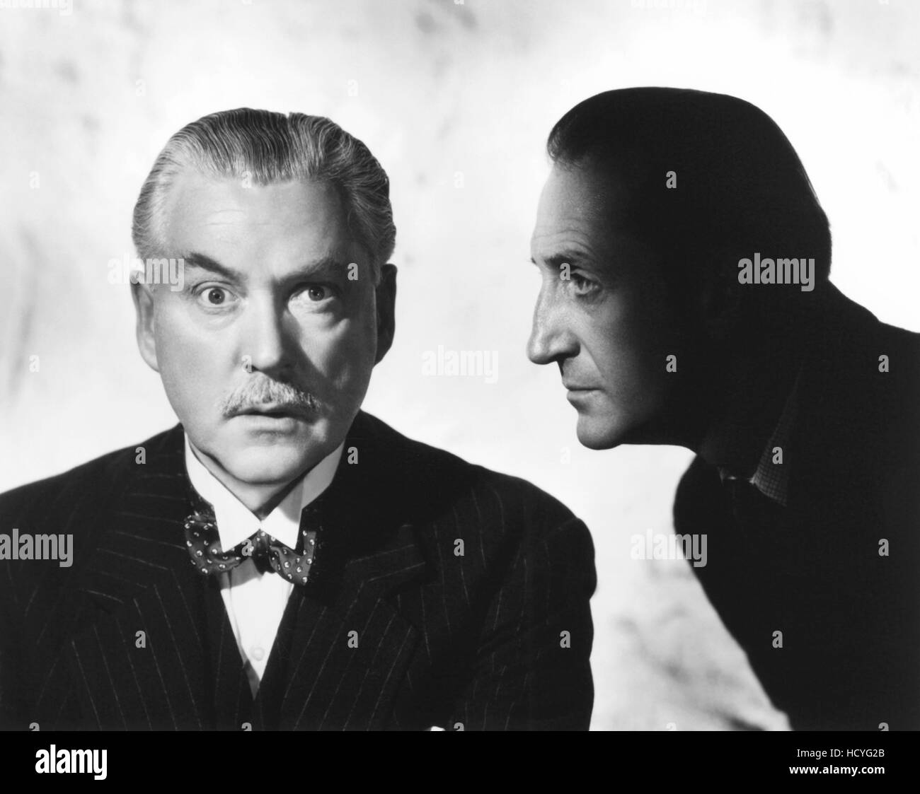 From left, Nigel Bruce, Basil Rathbone, in a Sherlock Holmes publicity shot, ca. 1940 Stock Photo