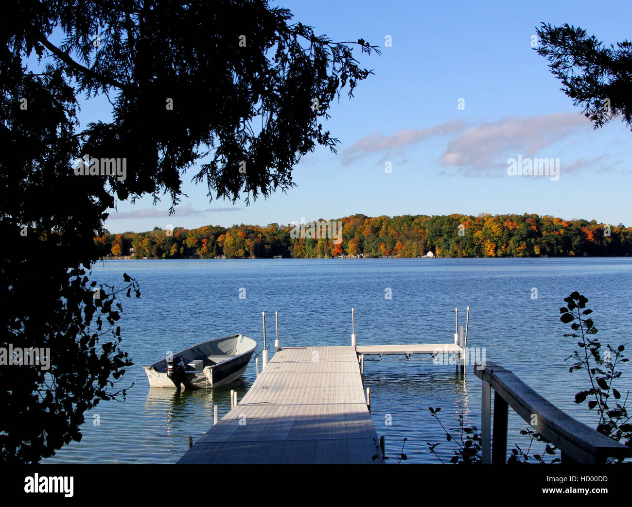motor boat pulled up to the dock on Elkhart Lake at Ostroff Resort in Wisconsin Stock Photo