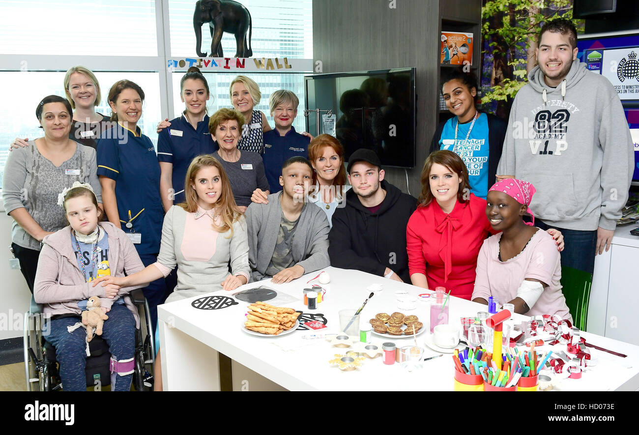 Princess Beatrice, the Duchess of York and Princess Eugenie meet young cancer patients and their families at the Teenage Cancer Trust's young persons unit at University College Hospital, London. Stock Photo